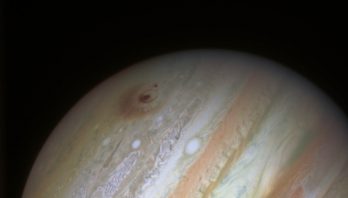 Photo of Jupiter with a red scar from the comet collision
