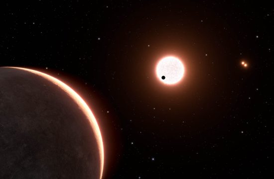 This is an artist's concept of the nearby exoplanet LTT 1445Ac, which is the size of Earth. The planet orbits a red dwarf star. The star is in a triple system, with two closely orbiting red dwarfs seen at upper right. The black dot in front of the bright light-red sphere at image center is planet LTT 1445Ac transiting the face of the star.