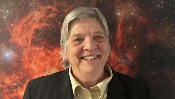 Headshot of Lori Allen smiling against a red cosmic background