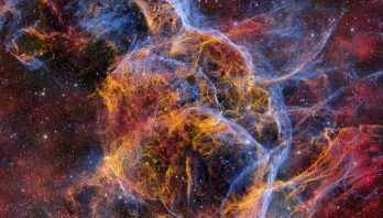 Ghostly Stellar Tendrils of the Vela Supernova Remnant- filaments in blue and orange fill the image.