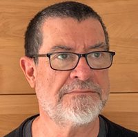 Headshot of a man wearing glasses.