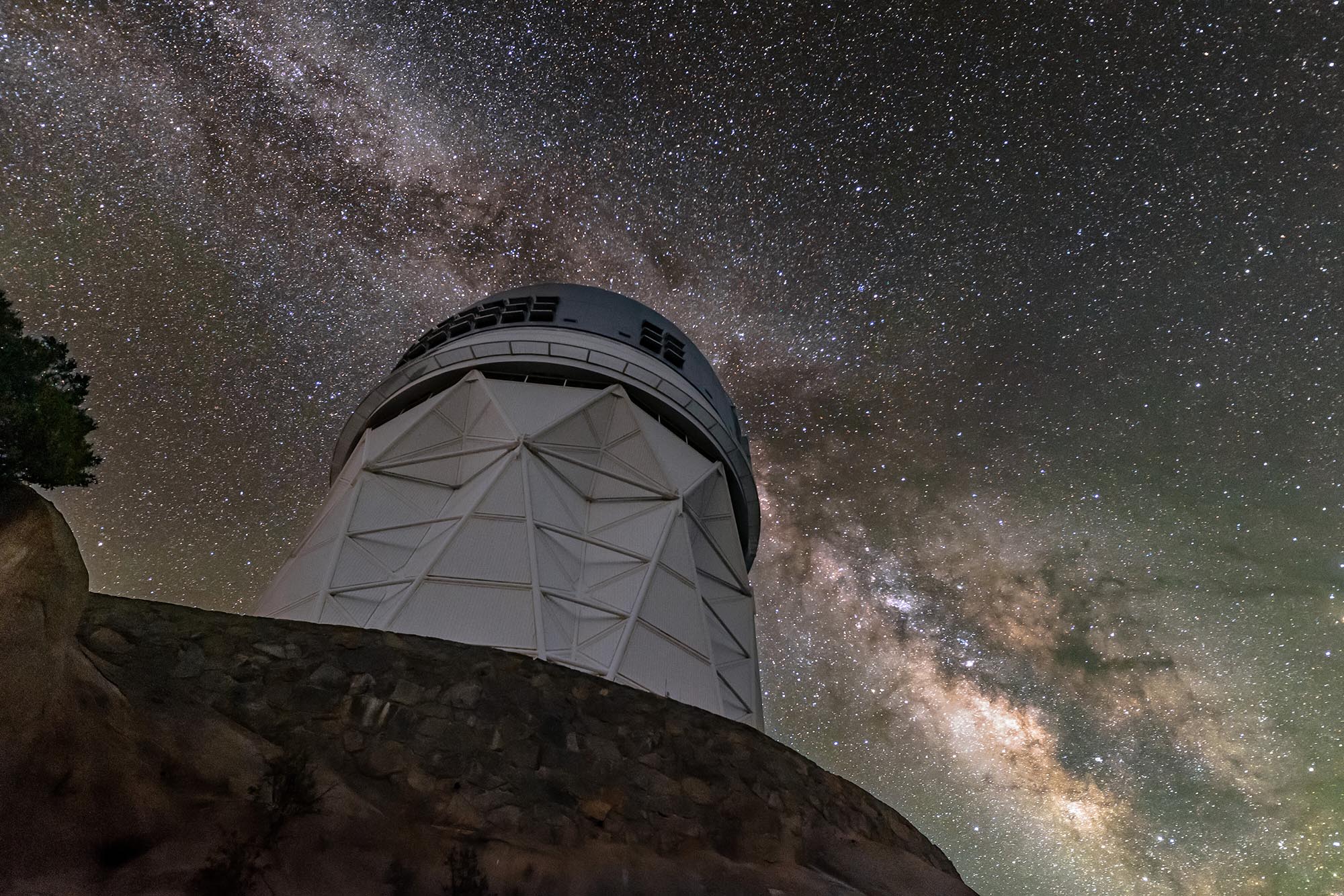 The sparkling band of the Milky Way Galaxy backdrops the Nicholas U. Mayall 4-meter Telescope, located at Kitt Peak National Observatory (KPNO) near Tucson, Arizona.