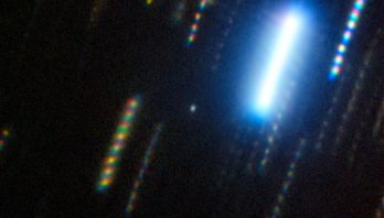 black background with multicolor streaks . One very bright streak is top right.