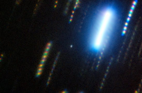 black background with multicolor streaks . One very bright streak is top right.