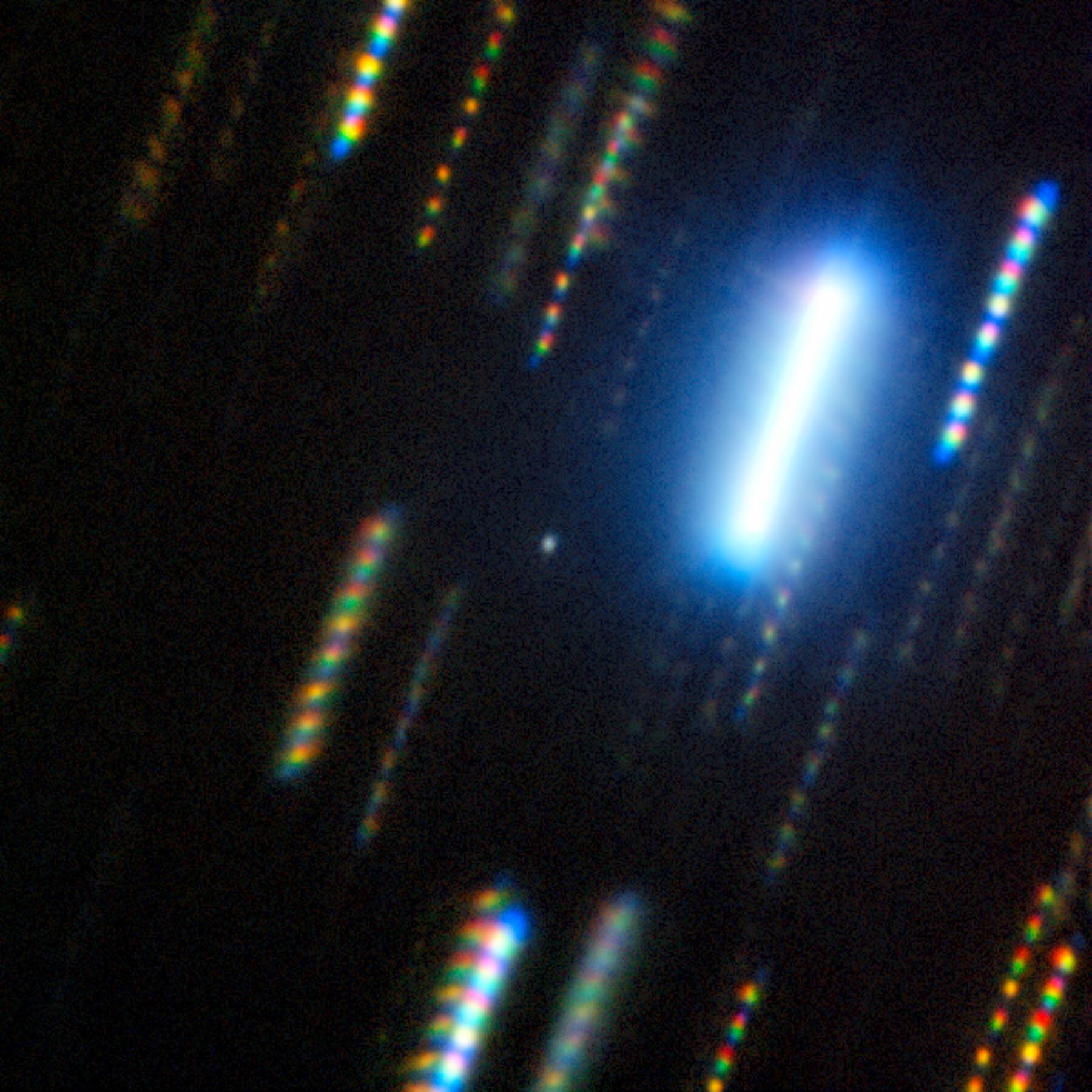 black background with multicolor streaks . One very bright streak is top right.