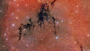 An overall red glittery image with a dark back crack running diagonally through it.