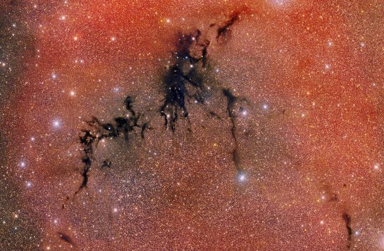 An overall red glittery image with a dark back crack running diagonally through it.