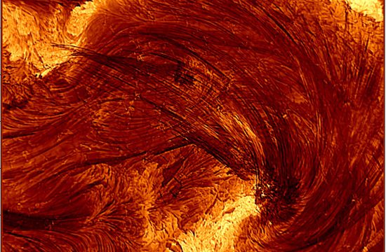A close up image of the Sun with an orange wave-like structure in th middle and bright yellow sections above and below ir. It is covered in dark lines indicating the direction of the wave.