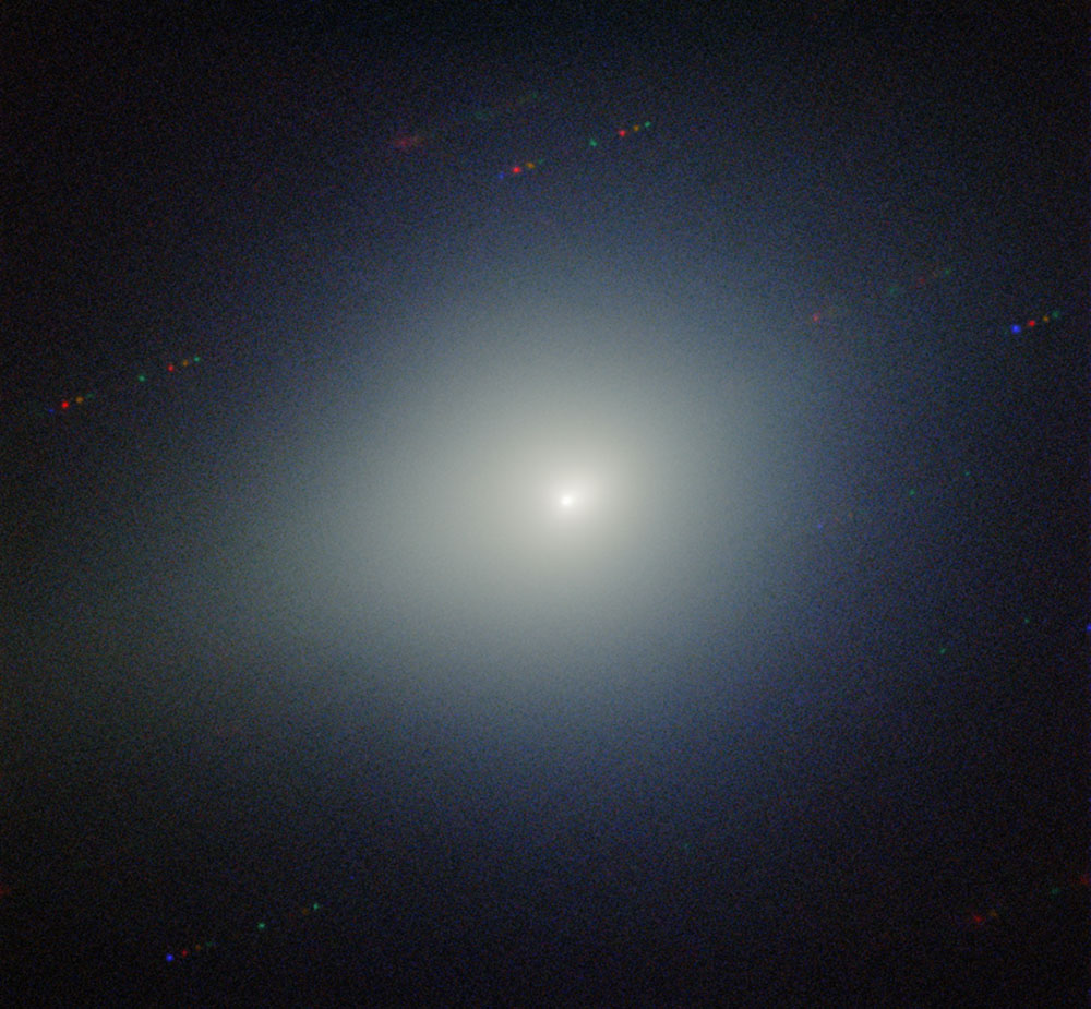 a bright light is in the center of the image is surrounded by a greenish glow on a dark black background.