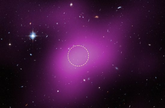 A region of space mostly filled with background galaxies, with one prominent star at upper left. A large blob of purple haze occupies much of the field. Within the purple region, an unremarkable area is outlined with a dashed white circle.