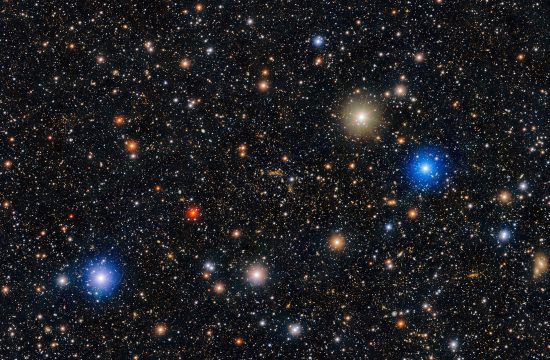 A black background is filled with stars -small and large glowing white, red, yellow and blue.