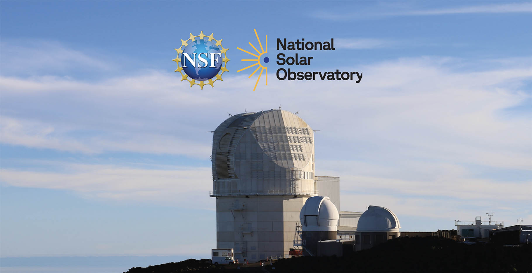 Large telescope agains a bright blue sky